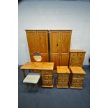 A PINE BEDROOM SUITE, comprising two double wardrobes, width 81cm x depth 53cm x height 181cm, a