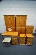 A PINE BEDROOM SUITE, comprising two double wardrobes, width 81cm x depth 53cm x height 181cm, a