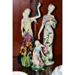 THREE OLD TUPTON WARE LADY AND GIRL FIGURES, all modelled wearing dresses with tube line decorated