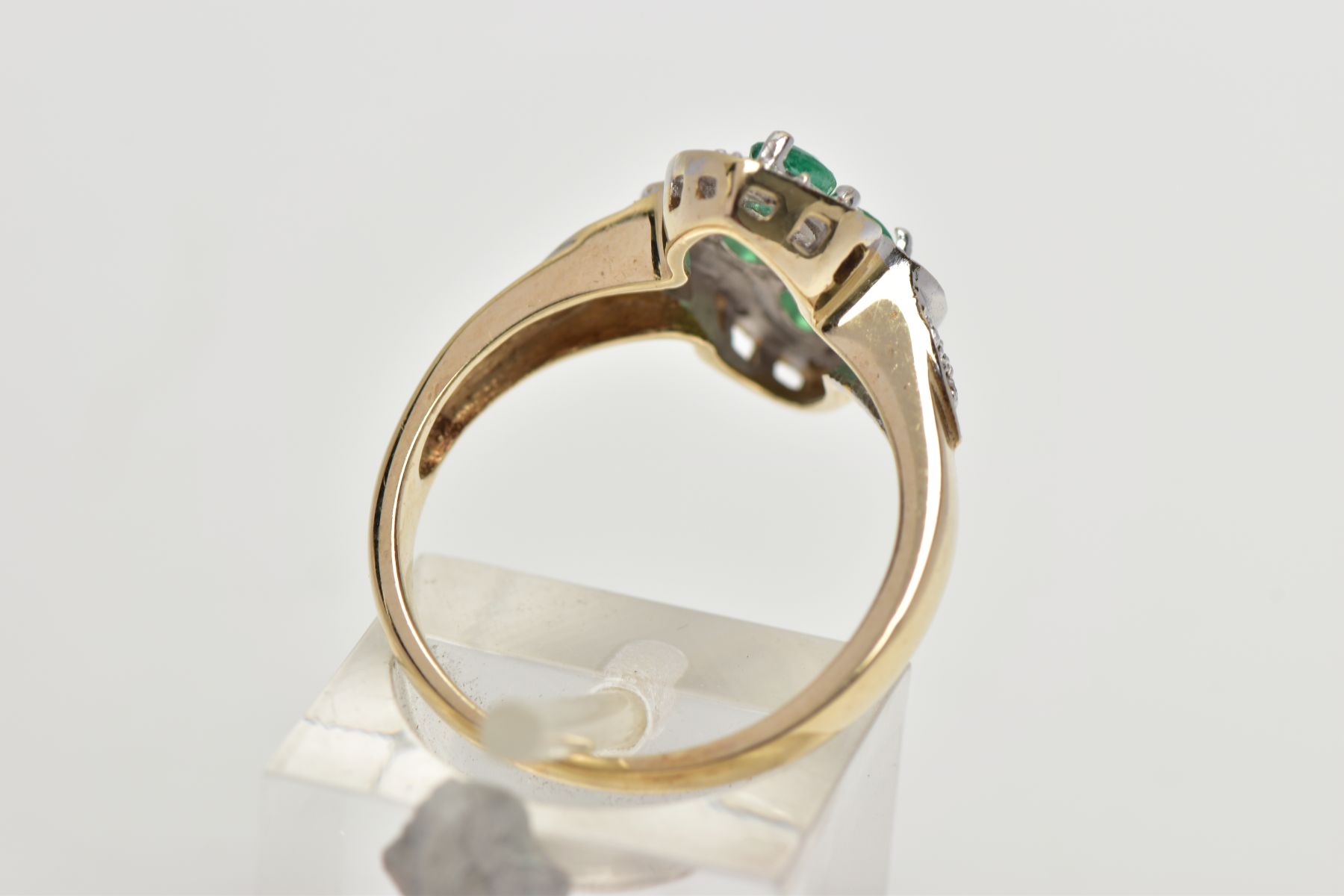 A 9CT YELLOW AND WHITE GOLD EMERALD AND DIAMOND DRESS RING, set with four oval cut emeralds, - Image 3 of 4