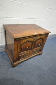 A REPRODUCTION OAK TV STAND with a fall front, width 66cm x depth 43cm x height 52cm (key) (