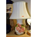 A MOORCROFT POTTERY TABLE LAMP BASE DECORATED WITH A CORAL 'HIBISCUS' DESIGN ON A CREAM