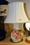 A MOORCROFT POTTERY TABLE LAMP BASE DECORATED WITH A CORAL 'HIBISCUS' DESIGN ON A CREAM