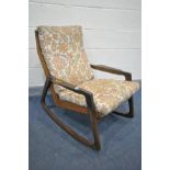 A MID-CENTURY TEAK ROCKING CHAIR, with shaped armrests, and floral cushions, width 66cm x depth 86cm
