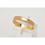 A YELLOW METAL BAND RING, worn engraved detail all round, ring size M leading edge, unmarked,