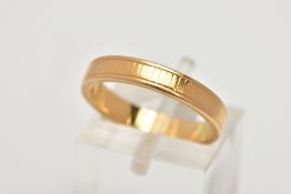 A YELLOW METAL BAND RING, worn engraved detail all round, ring size M leading edge, unmarked,