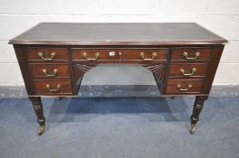 AN EARLY 20TH CENTURY VICTORIAN STYLE MAHOGANY DESK, with a black leather writing surface, and seven