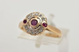 A 15CT GOLD, DIAMOND AND RUBY CLUSTER RING, of a circular design, centring on a circular cut