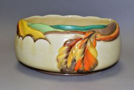 A CLARICE CLIFF AUTUMN LEAF FRUIT BOWL, with moulded, painted leaf design on a cream ground,