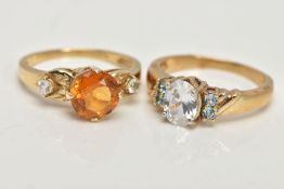 TWO 9CT GOLD GEM SET DRESS RINGS, the first centring on a four claw set, circular cut citrine,