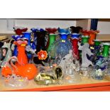 A QUANTITY OF COLOURED GLASSWARE AND CRYSTAL FIGURES, to include twenty one art glass, coloured