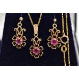 A MATCHING PENDANT NECKLACE AND EARRING SET, the pendant designed as an openwork flower, set with