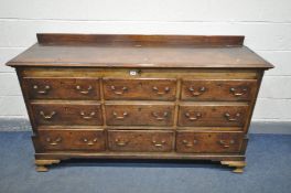 A GEORGIAN OAK AND CROSSBANDED LANCASHIRE CHEST, with hinged lid, six dummy drawers above three