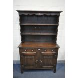 A REPRODUCTION OAK LINENFOLD DRESSER, with two drawers, width 115cm x depth 46cm x height 182cm x