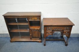 AN OLD CHARM OAK KNEE HOLE DESK, the forward moving top enclosing a secret compartment, over three