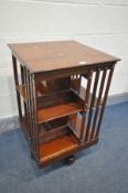 AN EARLY 20TH CENTURY MAHOGANY TWO TIER REVOLVING BOOKCASE, on ceramic casters, 49cm x height