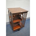 AN EARLY 20TH CENTURY MAHOGANY TWO TIER REVOLVING BOOKCASE, on ceramic casters, 49cm x height