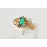 A YELLOW METAL SYNTHETIC EMERALD AND DIAMOND RING, set with a rectangular cut synthetic emerald,