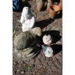 A COMPOSITE GARDEN FIGURE OF AN OTTER, a white painted gorilla garden figure, and two resin bird