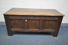 A GEORIAN OAK PANNELED COFFER, with a carved frieze, length 142cm x depth 60cm x height 67cm (