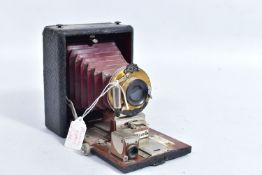 A MANHATTAN OPTICS POCKET WIZARD FIELD CAMERA with black covering over mahogany frame