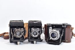 THREE ZEISS IKON SUPER IKONTA FOLDING FILM CAMERAS comprising of a 532/16 in leather case ( covering