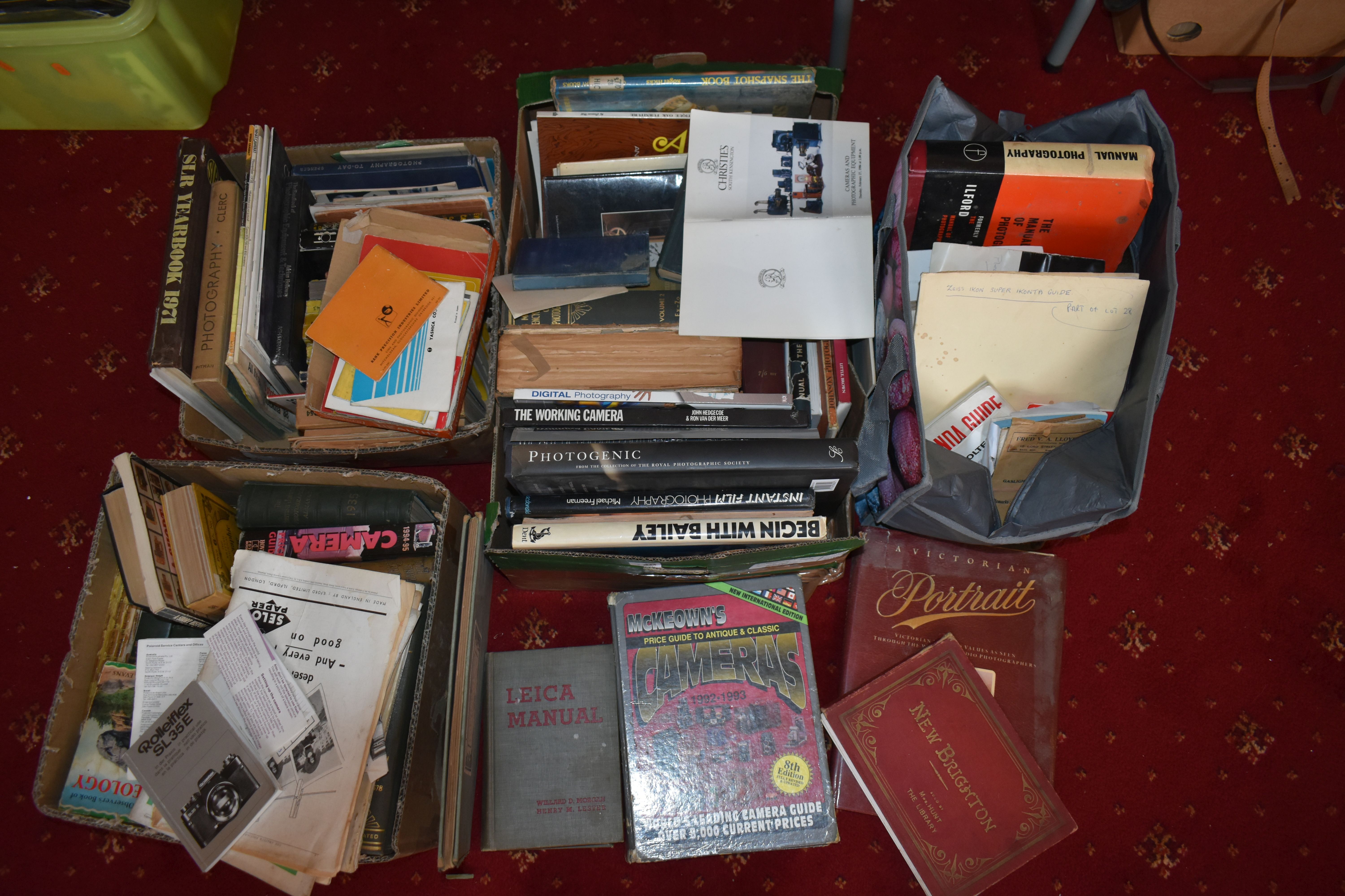 THREE TRAYS AND TWO BAGS CONTAINING BOOKS AND MANUALS on the subject of photography and cameras