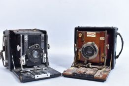 A SANDERSON FOLDING CAMERA with black covering over mahogany frame Bausch and Lamb shutter release