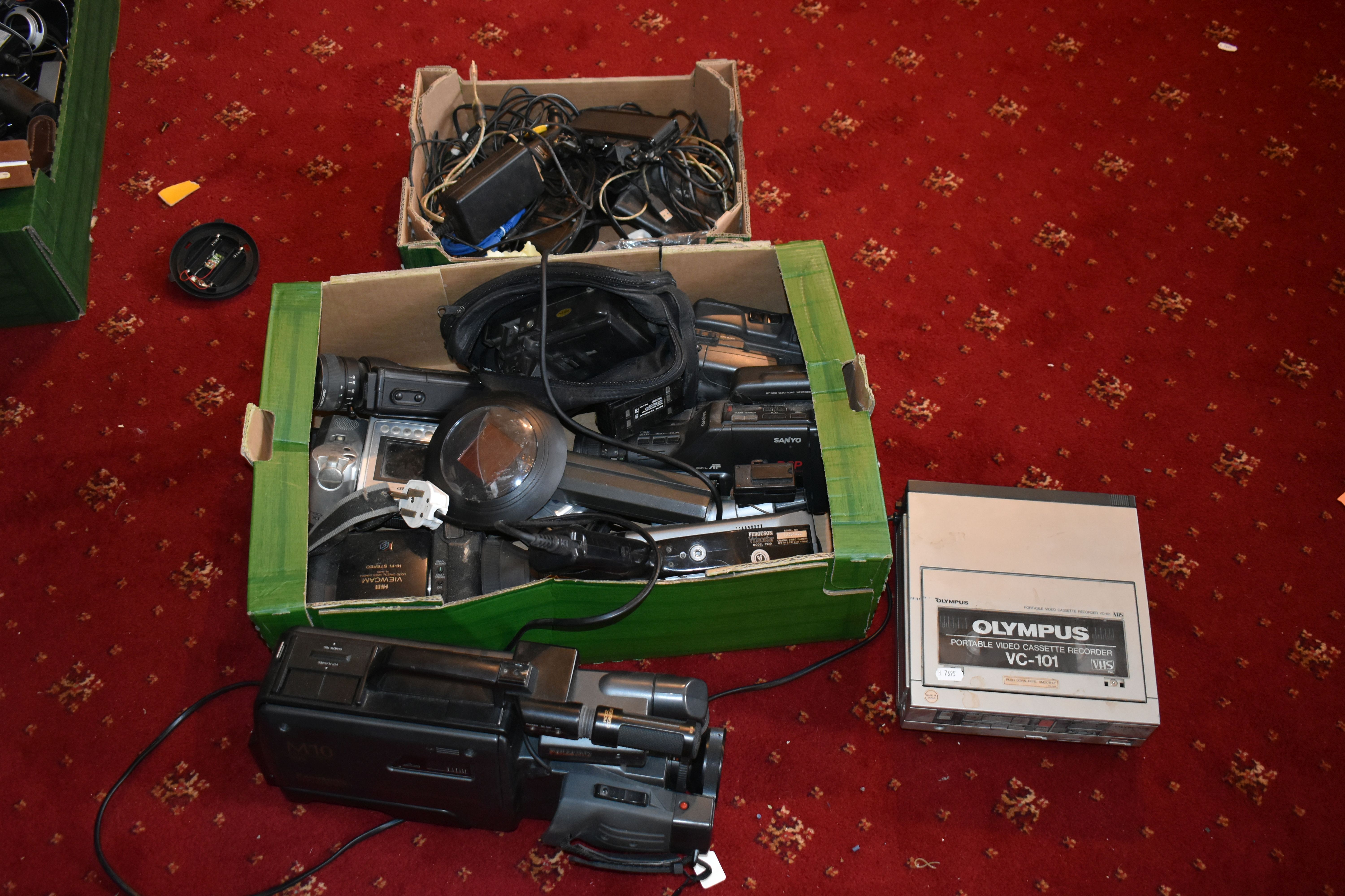 A TRAY AND A CASE CONTAINING VIDEO CAMERAS AND EQUIPMENT including a Panasonic M10, an Olympus VC101