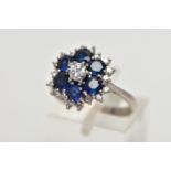 A SAPPHIRE AND DIAMOND CLUSTER RING, set with a principal round brilliant-cut diamond, surrounded by