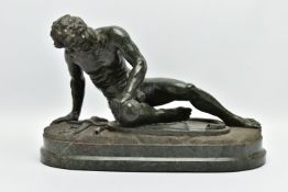 A 19TH CENTURY CARVED SERPENTINE FIGURE OF THE DYING GAUL, AFTER THE ANTIQUE, on an integral oval