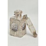 A LATE VICTORIAN SILVER MOUNTED GLASS SCENT BOTTLE OF SQUARE OUTLINE, hinged circular cover with