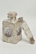 A LATE VICTORIAN SILVER MOUNTED GLASS SCENT BOTTLE OF SQUARE OUTLINE, hinged circular cover with