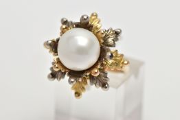 A WHITE AND YELLOW METAL CULTURED PEARL RING, of foliate design, set with a principal part drilled