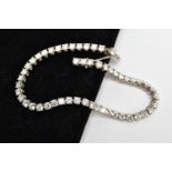 A MODERN PLATINUM DIAMOND LINE BRACELET, set with fifty-two round brilliant cut diamonds, four