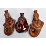 TWO VICTORIAN TREACLE GLAZED FLASKS IN THE FORM OF MERMAIDS, heights 20cm and 18cm and another