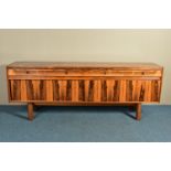 ROBERT HERITAGE (BRITISH 1927-) FOR ARCHIE SHINE, A 1960'S ROSEWOOD SIDEBOARD, the four drawers with