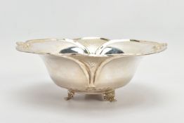 AN EARLY 20TH CENTURY STYLE WHITE METAL WAVY RIMMED BOWL, repousse decoration, on three feet, the