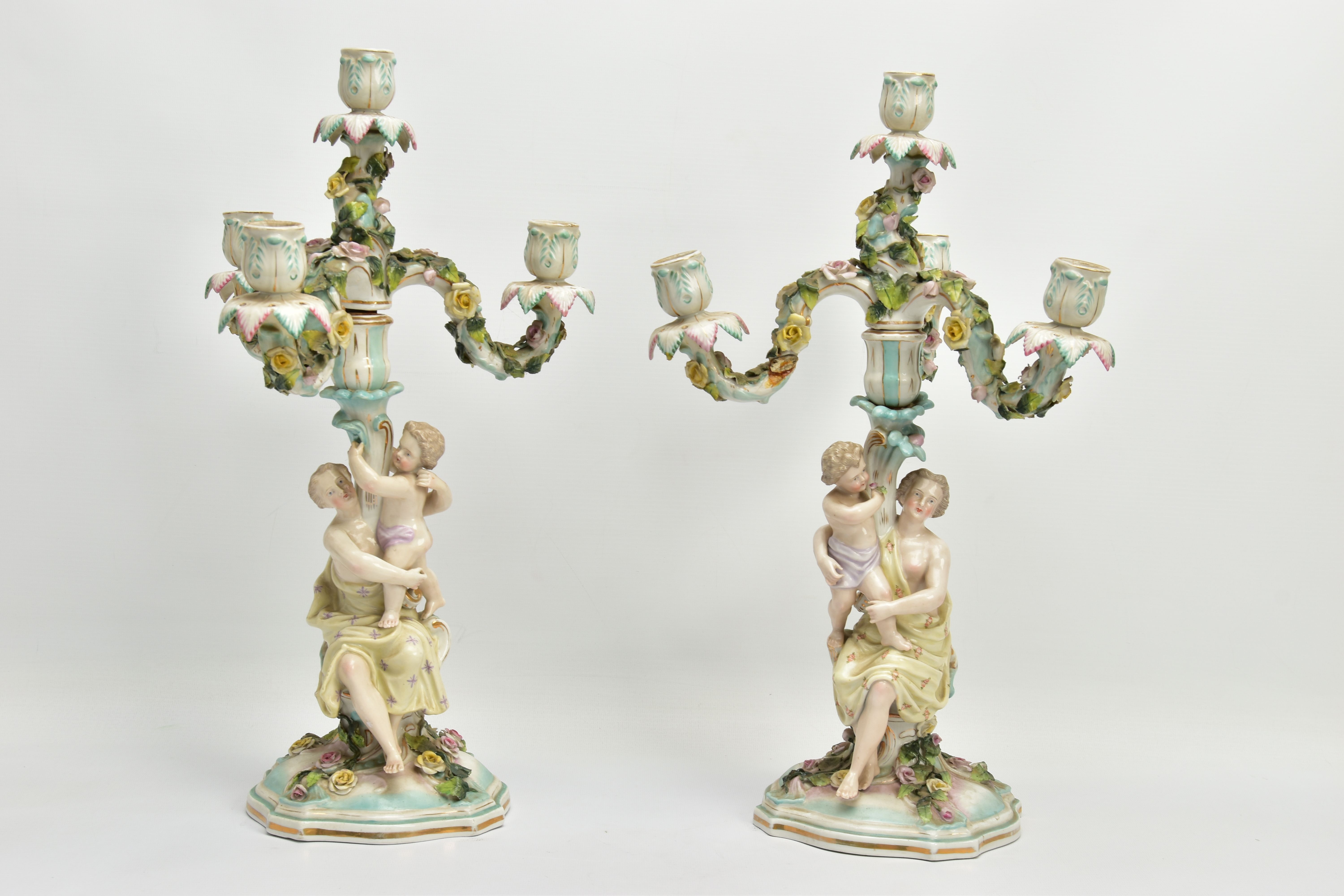A PAIR OF LATE 19TH / EARLY 20TH CENTURY PLAUE PORCELAIN FLORALLY ENCRUSTED FIGURAL CANDELABRA, each