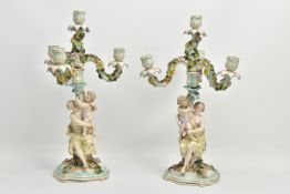 A PAIR OF LATE 19TH / EARLY 20TH CENTURY PLAUE PORCELAIN FLORALLY ENCRUSTED FIGURAL CANDELABRA, each