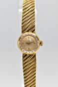 AN 18CT GOLD OMEGA WRISTWATCH, hand wound movement, round gold dial signed 'Omega', baton markers,