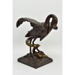 A 19TH CENTURY BRONZE FIGURE OF A STORK STANDING WITH OUTSTRETCHED WINGS, clutching an eel to the
