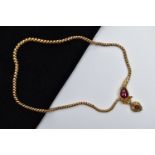 A VICTORIAN GARNET SET GOLD SNAKE NECKLACE, the serpent's head set with a pear shape garnet cabochon