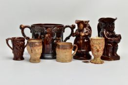 A VICTORIAN TREACLE GLAZED LOVING CUP, decorated in relief with bust of Nelson, fighting dogs and