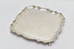 A GEORGE V SILVER SALVER OF SHAPED SQUARE OUTLINE, pie crust edge, plain surface, four hoof feet,