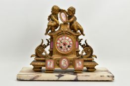 A MID 19TH CENTURY FRENCH GILT METAL AND PORCELAIN MOUNTED FIGURAL MANTEL CLOCK, the case surmounted