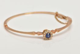 AN EARLY TWENEITH CENTURY GOLD SAPPHIRE AND DIAMOND BANGLE, a yellow gold oval hinged bangle, set