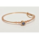 AN EARLY TWENEITH CENTURY GOLD SAPPHIRE AND DIAMOND BANGLE, a yellow gold oval hinged bangle, set