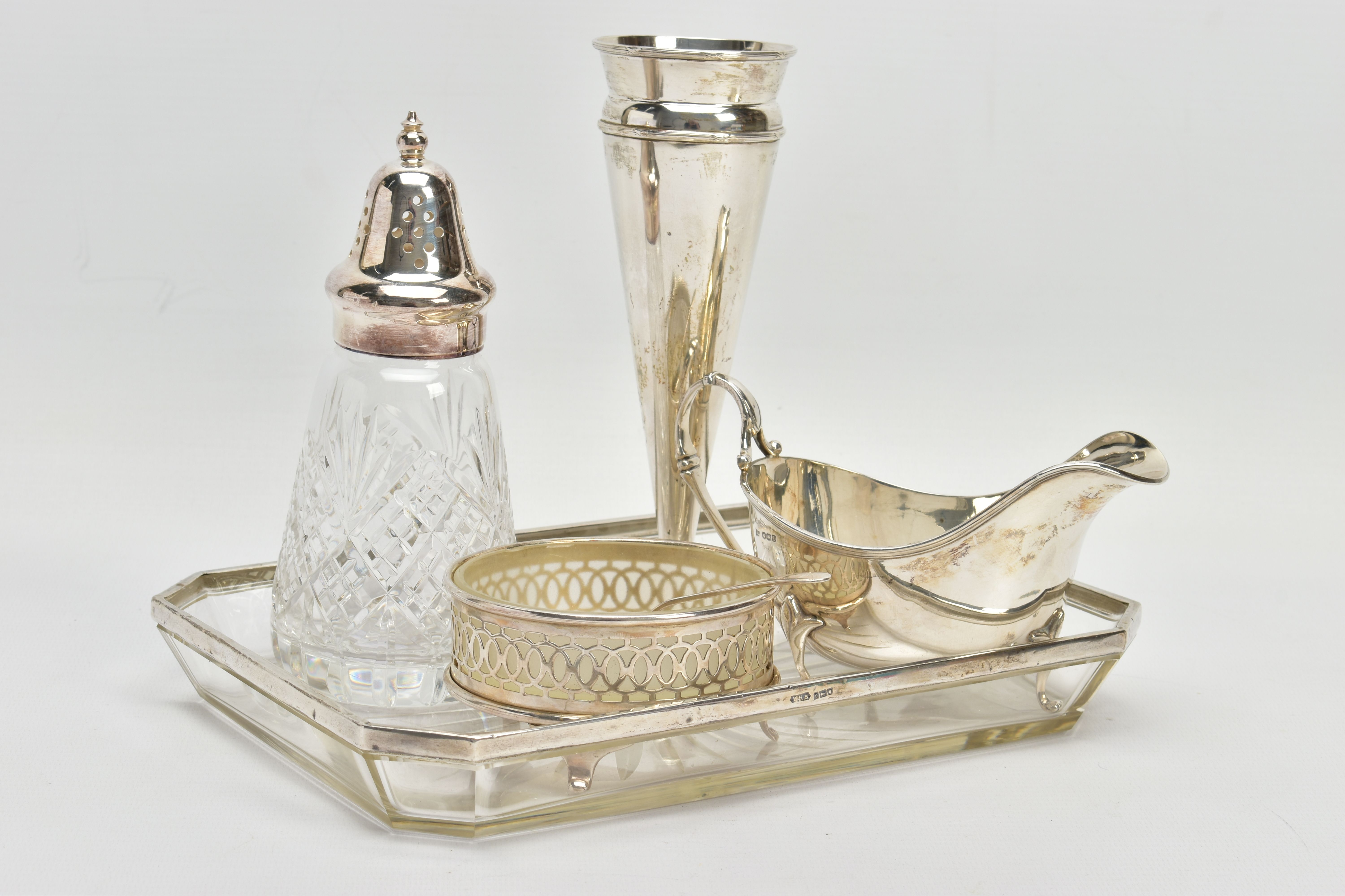 A PARCEL OF SILVER AND SILVER MOUNTED ITEMS, comprising a George V sauce boat, on three cabriole
