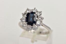 AN 18CT WHITE GOLD, SAPPHIRE AND DIAMOND CLUSTER RING, set with a cushion-shaped mixed-cut sapphire,